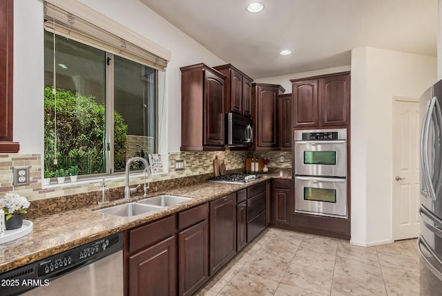 3622 E Sparrow Pl, Chandler, AZ 85286 - kitchen with stainless steel appliances, decorative backsplash, dark brown cabinetry, dark stone countertops, and recessed lighting