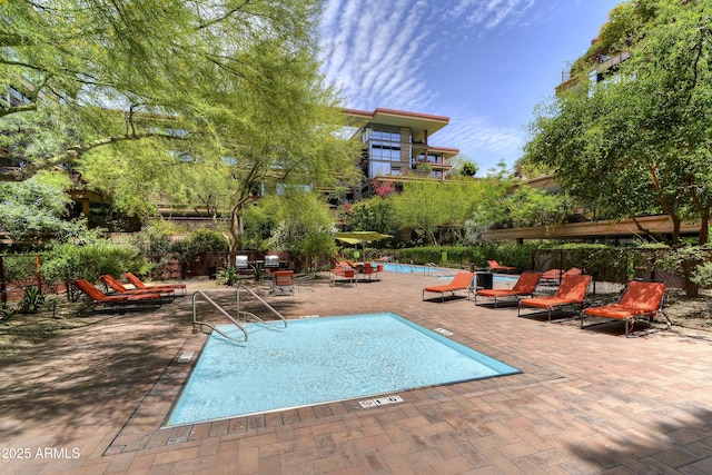 pool with fence and a patio area