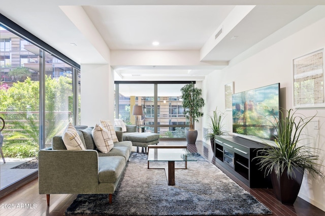 living area with visible vents, wood finished floors, and plenty of natural light