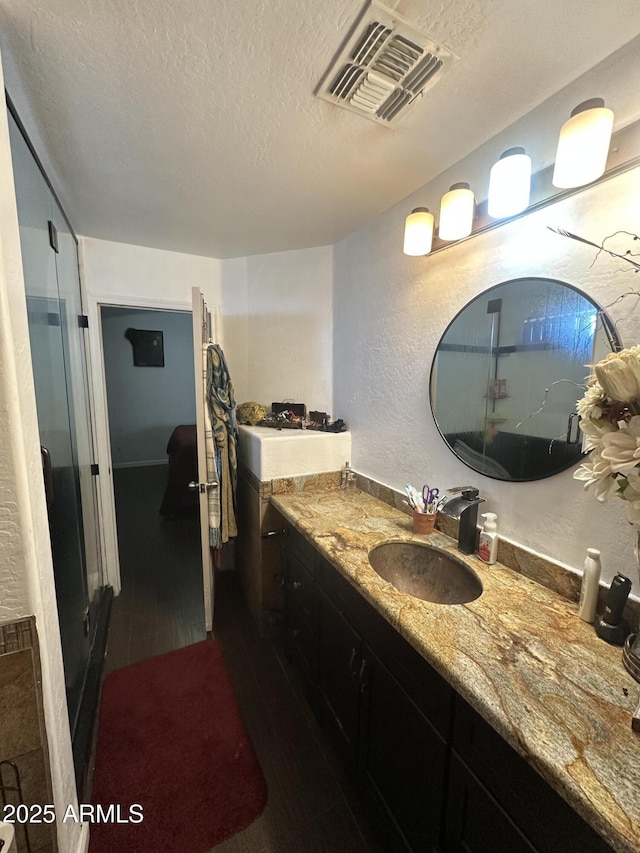 bathroom featuring vanity and a textured ceiling