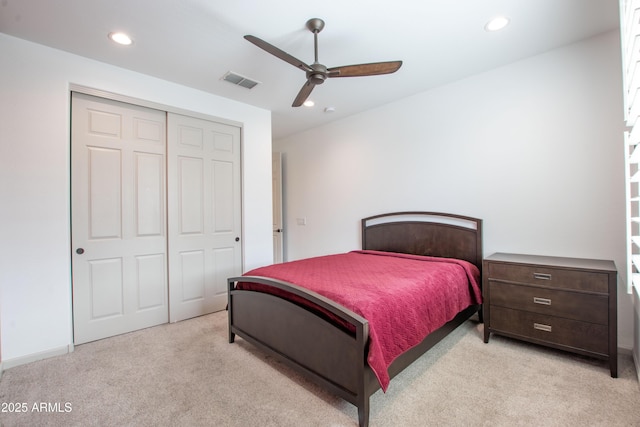 bedroom with light carpet, visible vents, ceiling fan, a closet, and recessed lighting