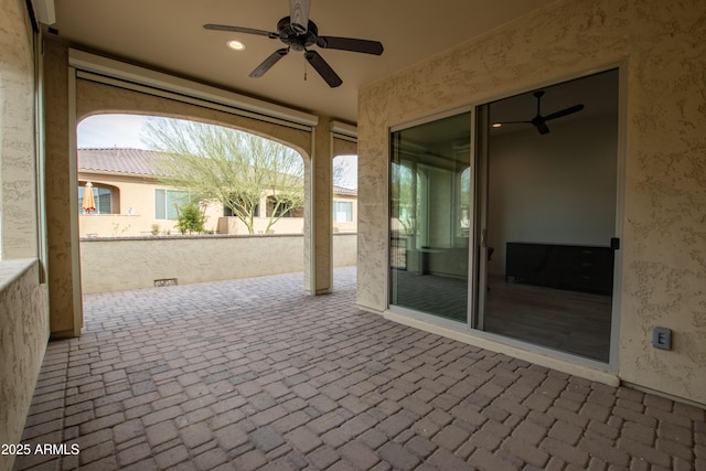 view of patio / terrace featuring fence and a ceiling fan