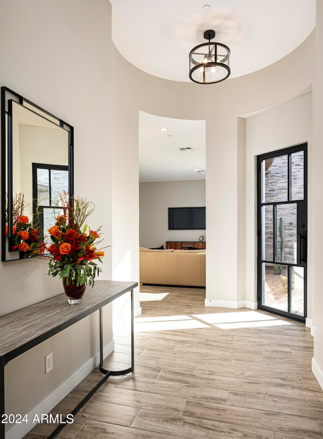 corridor with light hardwood / wood-style floors