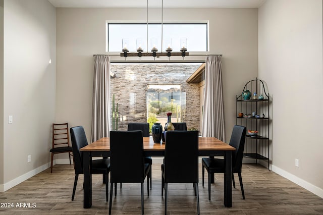 dining area with an inviting chandelier and hardwood / wood-style flooring