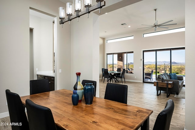 dining area with light hardwood / wood-style floors and ceiling fan