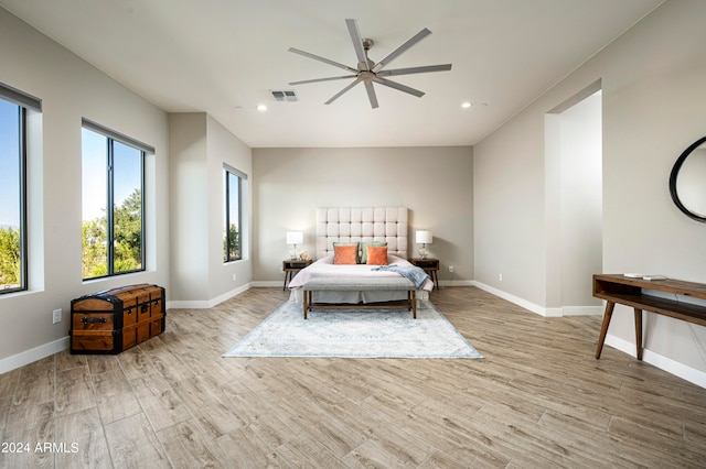 bedroom with light hardwood / wood-style floors and ceiling fan