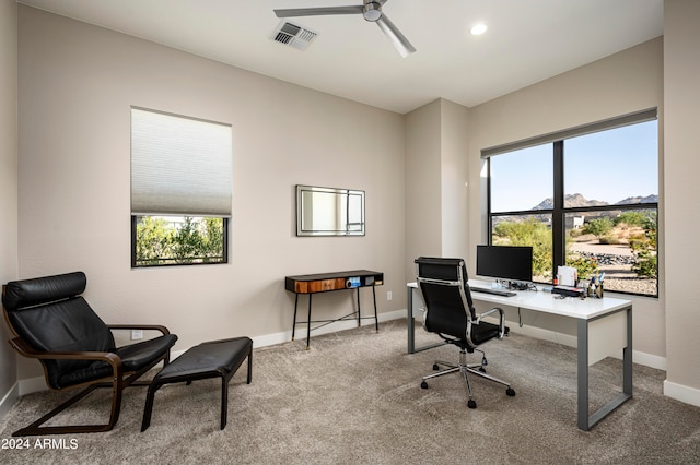 office space featuring ceiling fan, light carpet, and plenty of natural light