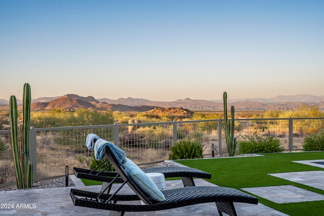 yard at dusk featuring a mountain view