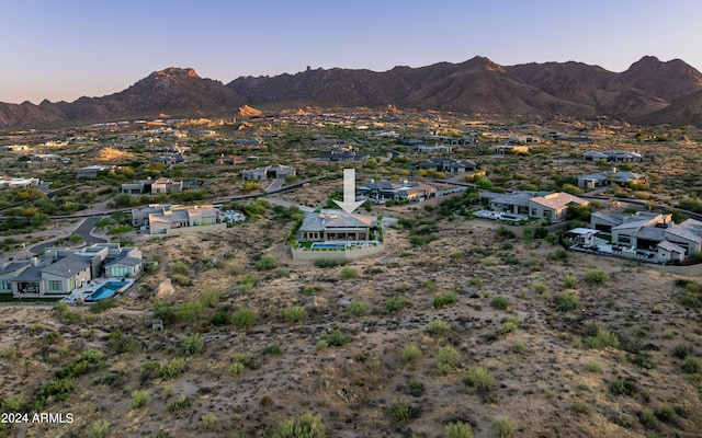 aerial view at dusk featuring a mountain view