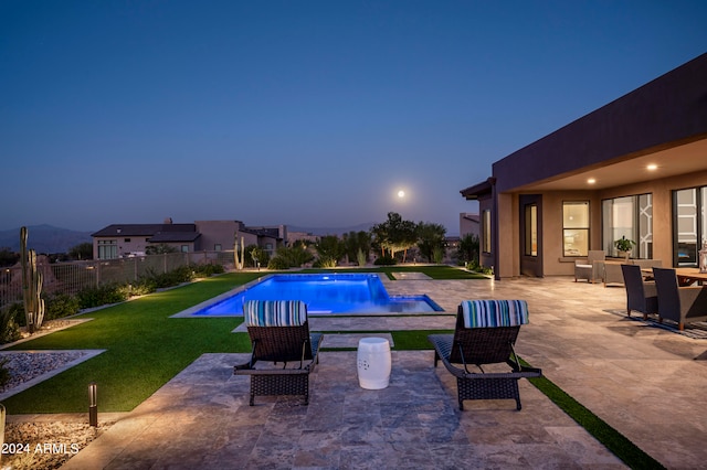 view of swimming pool featuring a lawn and a patio