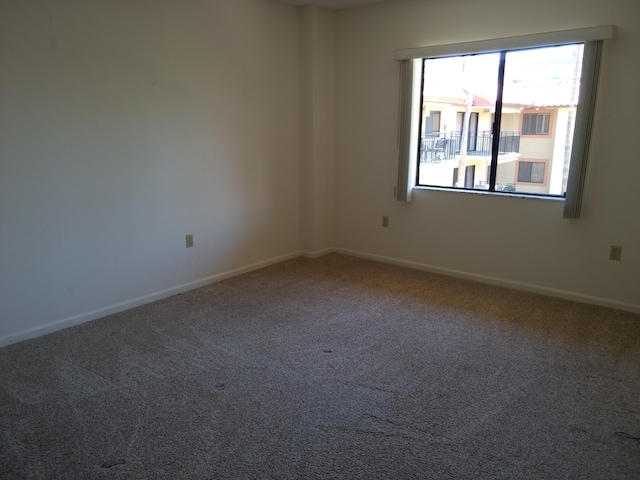 unfurnished room featuring carpet flooring