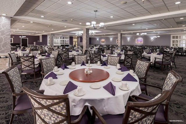 dining area featuring carpet and a notable chandelier