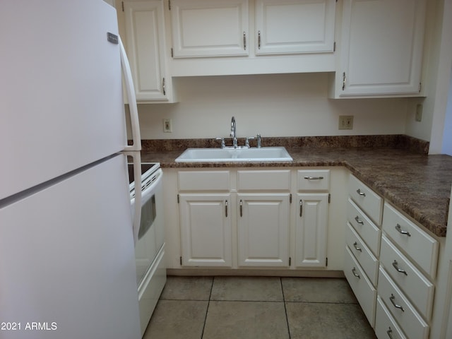 kitchen with white appliances, sink, and white cabinets