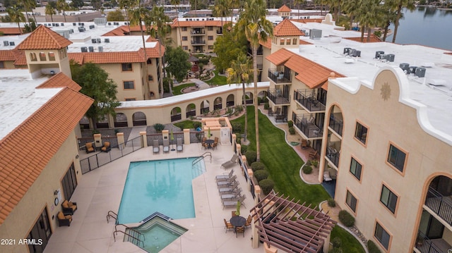 snow covered pool featuring a patio and a water view