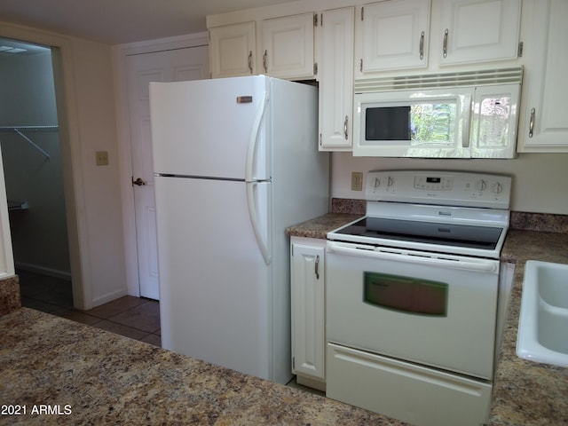 kitchen featuring white cabinetry, sink, tile patterned floors, and white appliances