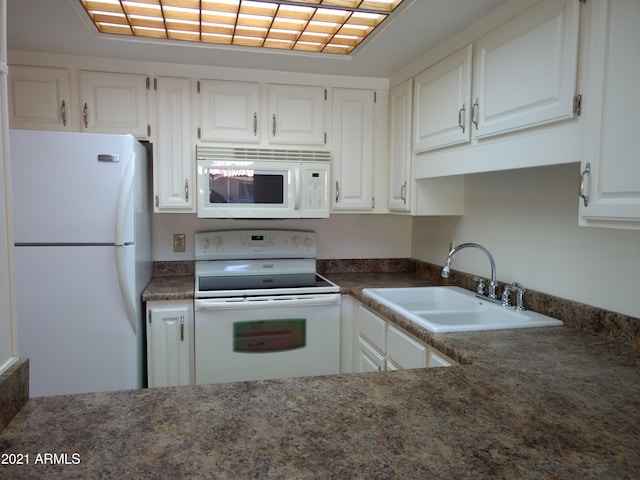 kitchen with white cabinetry, sink, and white appliances