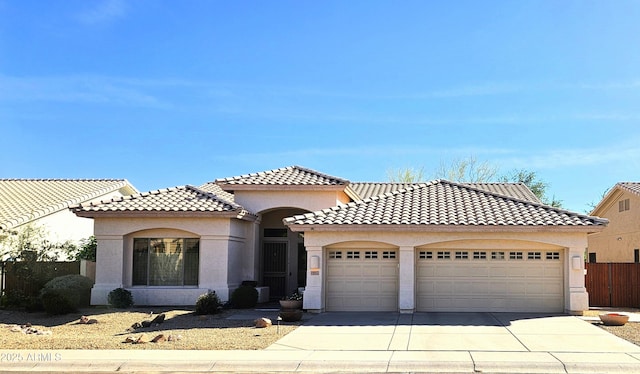 1943 E Drake Dr, Tempe, AZ 85283 - mediterranean / spanish home with an attached garage, concrete driveway, stucco siding, and a tile roof