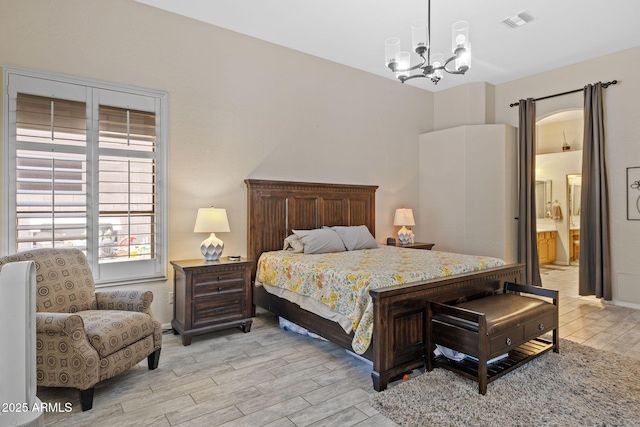 1943 E Drake Dr, Tempe, AZ 85283 - bedroom featuring light wood-style floors, a chandelier, and connected bathroom