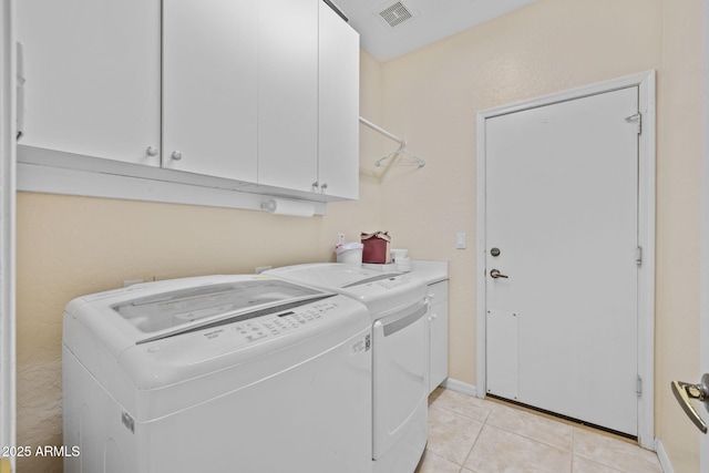 1943 E Drake Dr, Tempe, AZ 85283 - washroom featuring cabinet space, independent washer and dryer, light tile patterned floors, and baseboards