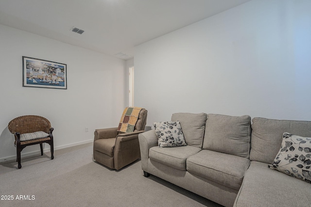 living room featuring baseboards, visible vents, and light colored carpet