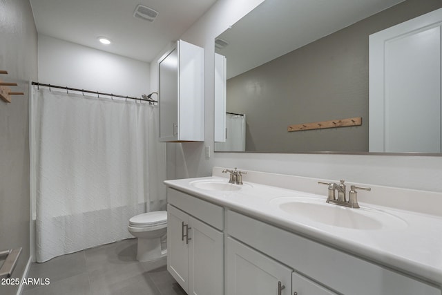 bathroom featuring shower / bath combination with curtain, a sink, toilet, and double vanity