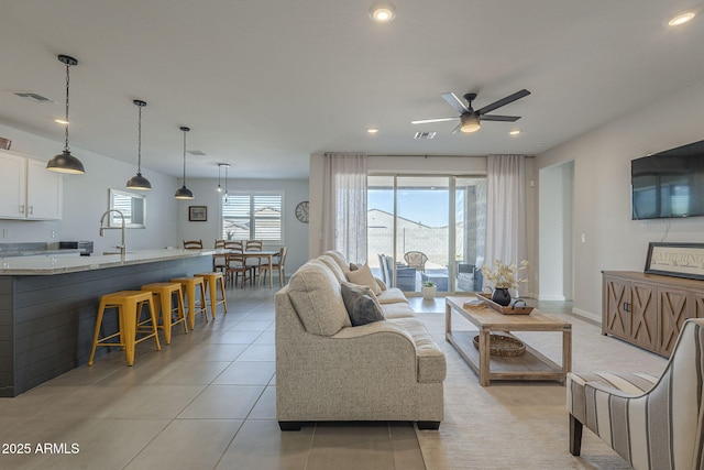 living area featuring recessed lighting, a healthy amount of sunlight, visible vents, and light tile patterned flooring