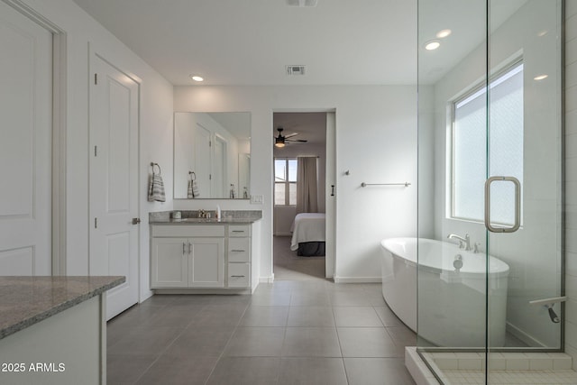 ensuite bathroom with visible vents, connected bathroom, tile patterned flooring, vanity, and a shower stall