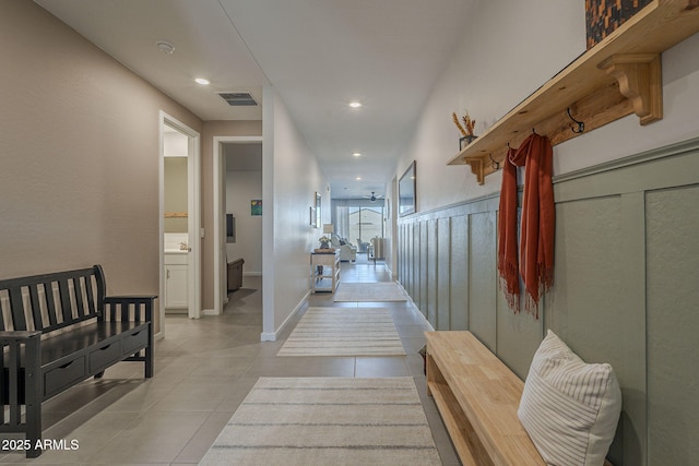 corridor with light tile patterned floors, baseboards, visible vents, and recessed lighting