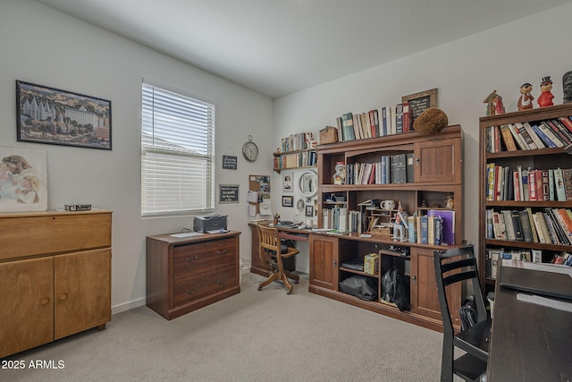 office space featuring light carpet and baseboards