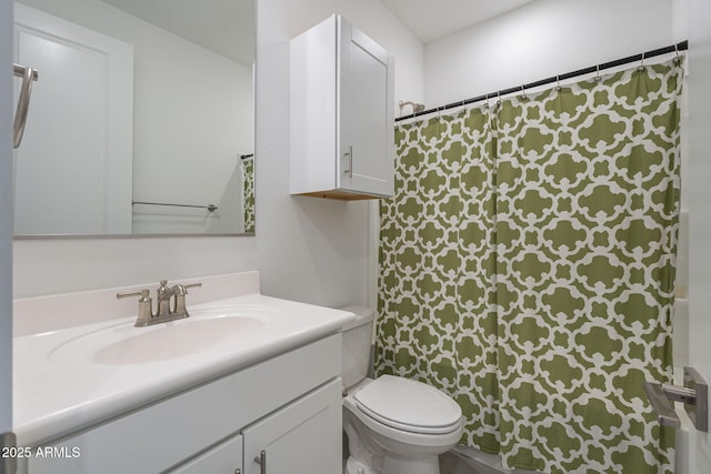 bathroom featuring vanity and toilet