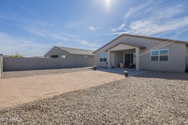 back of property featuring a patio area and a fenced backyard