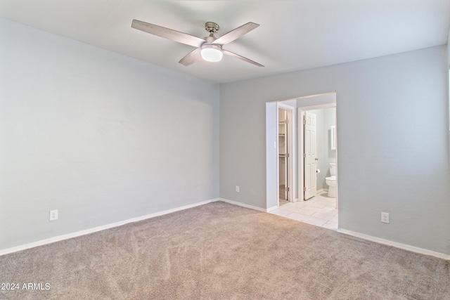 carpeted spare room with ceiling fan