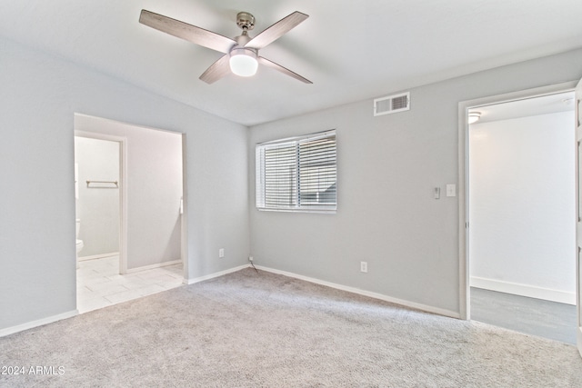 unfurnished room featuring light colored carpet, vaulted ceiling, and ceiling fan