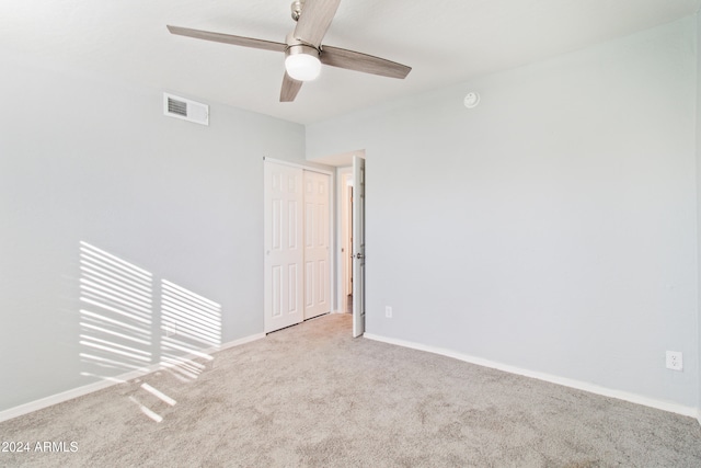 carpeted empty room with ceiling fan