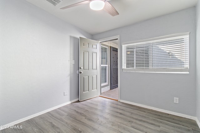 spare room featuring ceiling fan and hardwood / wood-style floors