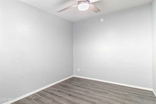 empty room with ceiling fan and dark wood-type flooring