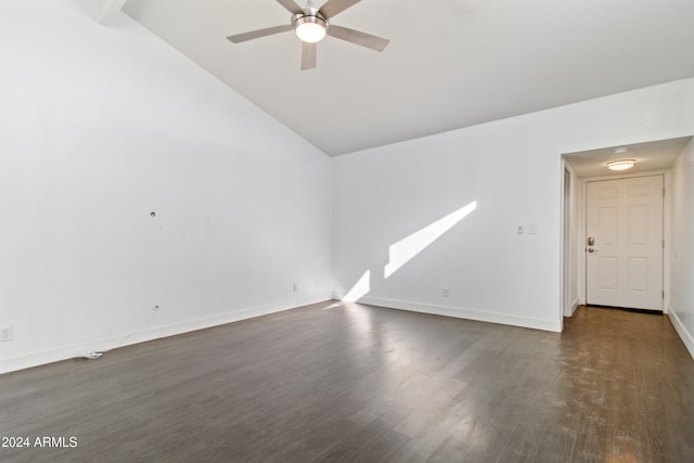 empty room with vaulted ceiling, ceiling fan, and dark wood-type flooring