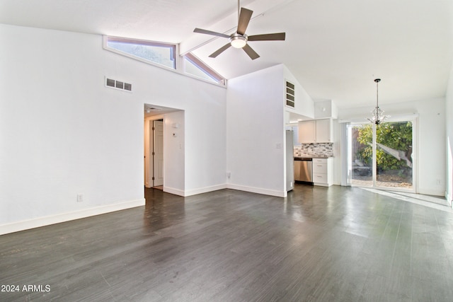 unfurnished living room featuring ceiling fan with notable chandelier, dark hardwood / wood-style floors, and high vaulted ceiling