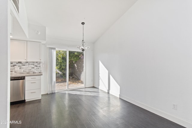 unfurnished living room with dark wood-type flooring and a notable chandelier