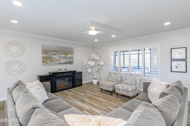 living room featuring crown molding, ceiling fan, and hardwood / wood-style floors