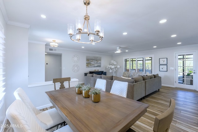 dining room featuring ornamental molding and hardwood / wood-style floors