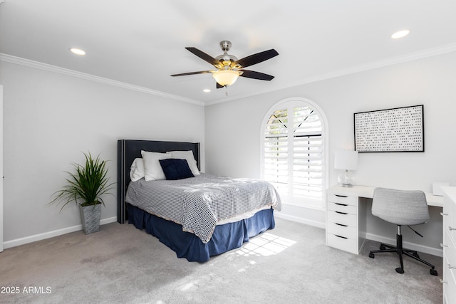 bedroom with crown molding, light colored carpet, and ceiling fan