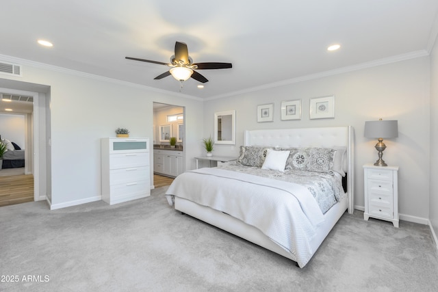 carpeted bedroom with ceiling fan, ornamental molding, and ensuite bathroom