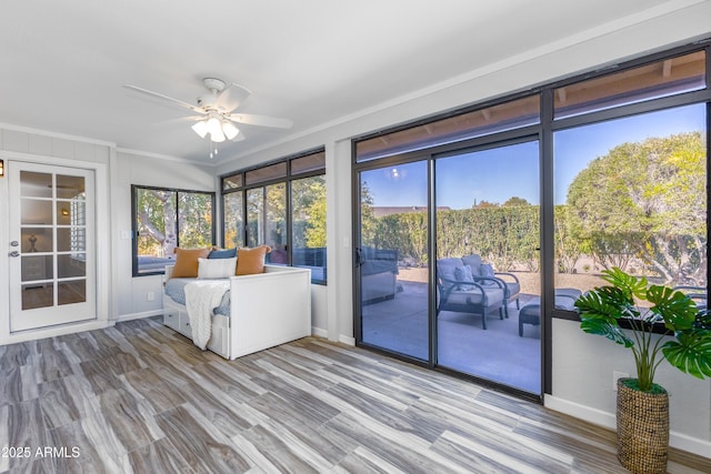 unfurnished sunroom with a wealth of natural light and ceiling fan