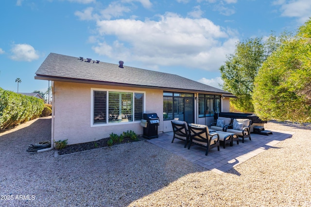 rear view of property with an outdoor living space, a jacuzzi, and a patio area