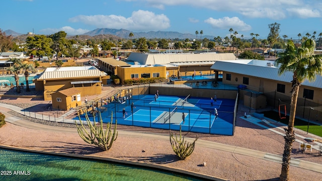 view of swimming pool featuring a mountain view and tennis court