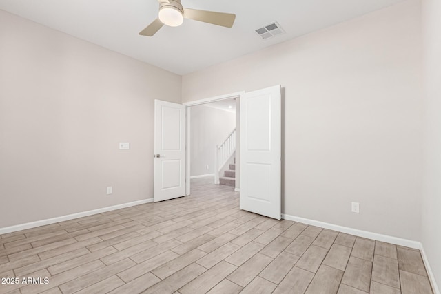 spare room with ceiling fan and light hardwood / wood-style flooring