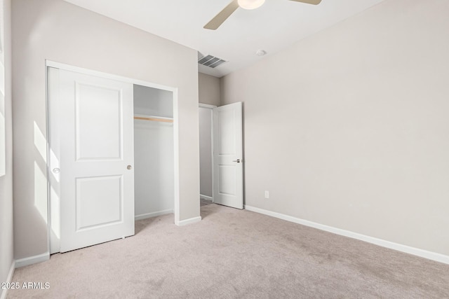 unfurnished bedroom with light carpet, ceiling fan, and a closet