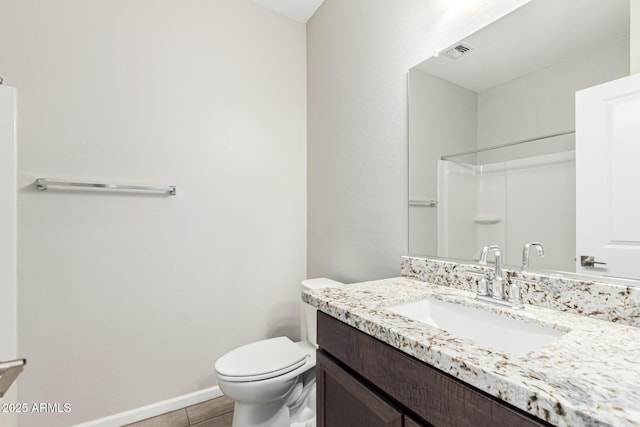 bathroom with walk in shower, vanity, and toilet