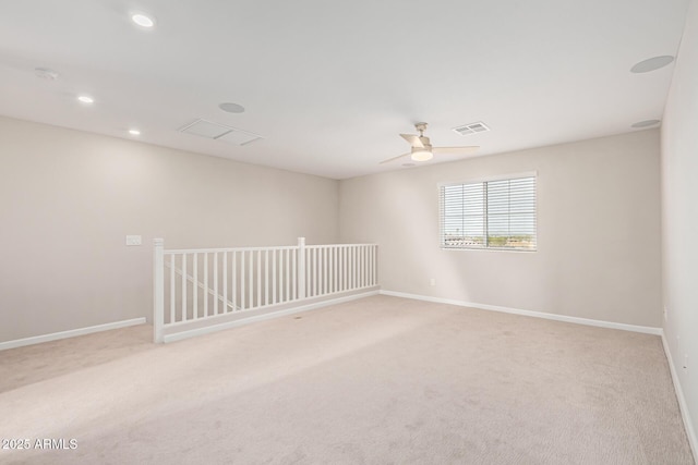 empty room featuring ceiling fan and light colored carpet